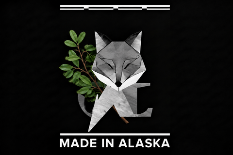 Geometric fox design with greenery and 'Made in Alaska' text on a black background