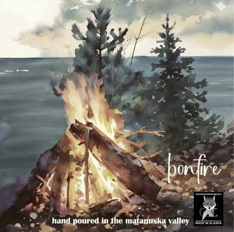 Watercolor-style artwork showing a campfire burning near evergreen trees by the ocean, with the text 'bonfire' and 'hand poured in the matanuska valley' plus a small 'Made in Alaska' logo.