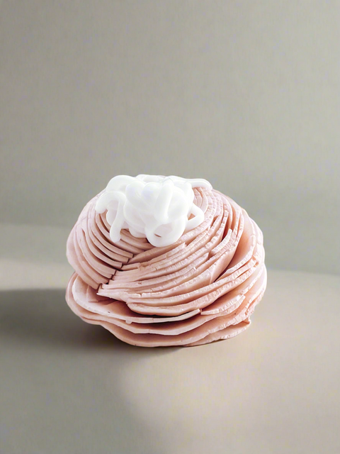 grey fox lotion sitting on top of a dried pink rose, made in alaska