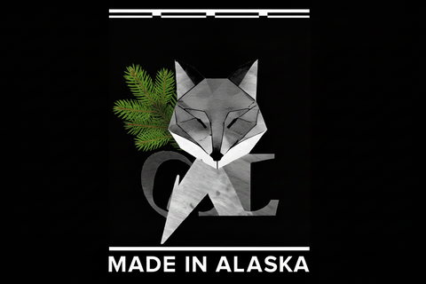 Geometric fox design with a pink heart and 'Made in Alaska' text on a black background