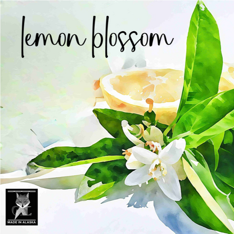 Lemon blossom with green leaves and a lemon on a light background, featuring the text 'lemon blossom' and 'Made in Alaska'.