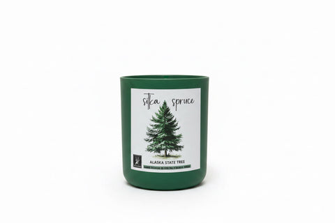 matte pine candle with a label featuring Sitka Spruce Alaska State Tree design on a white background