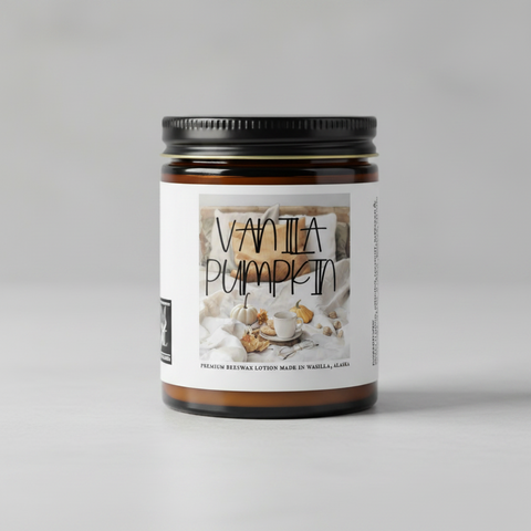 Vanilla Pumpkin premium beeswax lotion, in an amber glass jar, showing a front label with a cozy autumn scene, a small square 'Made in Alaska' badge, and a vertical ingredients list on a white background.