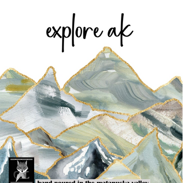 Artistic depiction of mountains with 'explore ak' text and grey fox logo in the corner.