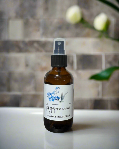 Bottle of 'Forget-me-not' with a floral label on a kitchen counter