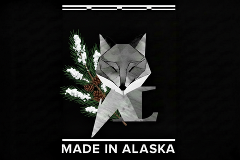 Geometric fox design with snow on pine sprigs, with 'Made in Alaska' text on a black background