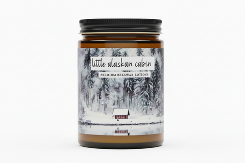 amber jar of premium beeswax lotion by grey fox candles, Little Alaskan Cabin, picture of a little cabin in snowy woods