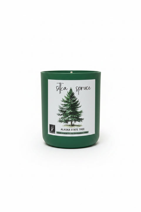 pine green candle with a label featuring Sitka Spruce Alaska State Tree design on a white background