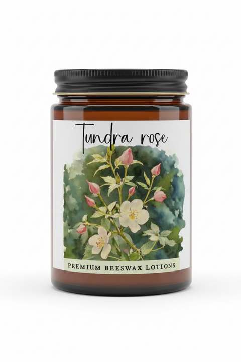 A product information card for Tundra Rose Premium Beeswax Lotions. The card features a central floral illustration of a yellow and white flower with pink buds on a green and blue watercolor background.