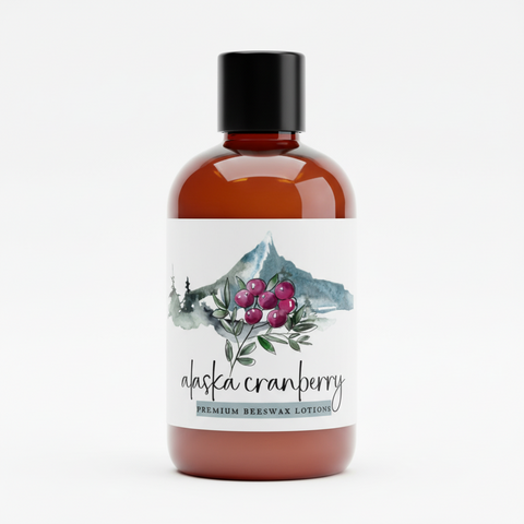 Bottle of Alaska Cranberry premium beeswax lotion with a label featuring cranberries and mountains on a white background.
