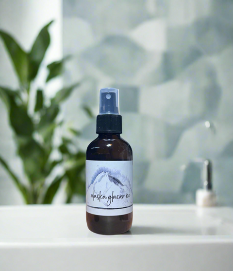 Bottle of 'Alaska Glacier' spray on a white surface with a blurred background