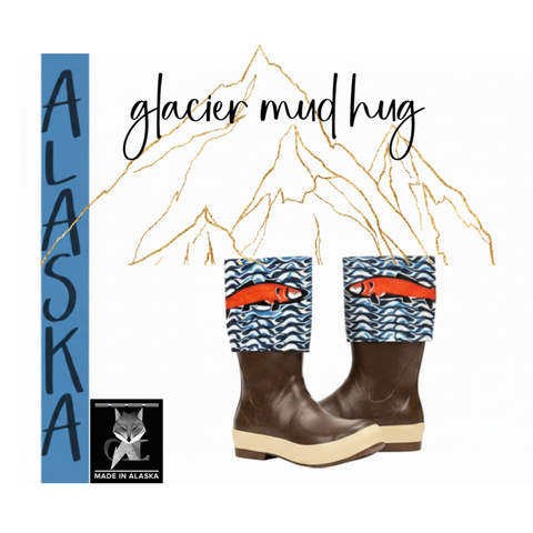 Glacier Mud Hug candle label illustration showing Alaska water boots with salmon print and mountain outline, Made in Alaska badge, Grey Fox Candles