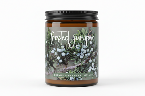 Candle jar labeled 'Frosted Juniper' with a decorative label on a white background