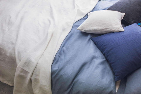 "Soft white and blue linen bedding and pillows, perfect for spritzing with Alaska forget me not room mist, Grey Fox Candles"