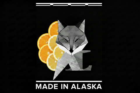 Geometric fox design with oranges and 'Made in Alaska' text on a black background