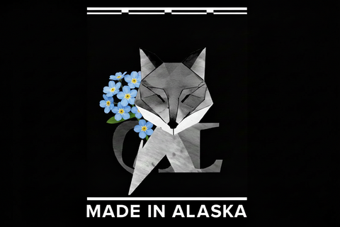 Geometric fox design with forget me not flowers and 'Made in Alaska' text on a black background