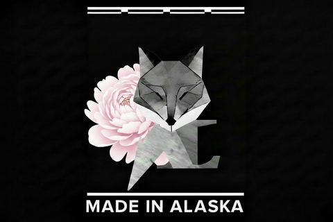 A black graphic print featuring a stylized gray geometric fox head next to a light pink peony, with the text 'MADE IN ALASKA' in white below.