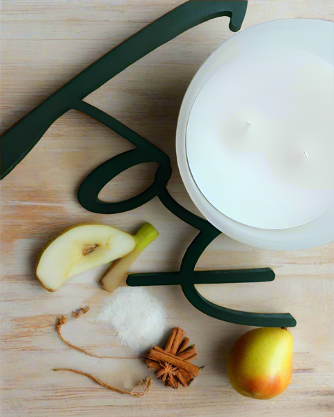 spiced pears, cinnamon and sugar scattered about a cutting board with the text FOX and a two wick candle