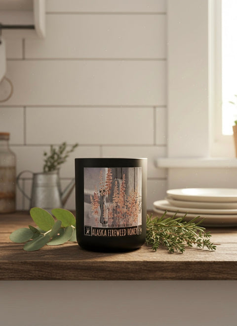 Alaska fireweed honey candle sitting on a farmhouse counter, label says made in Alaska