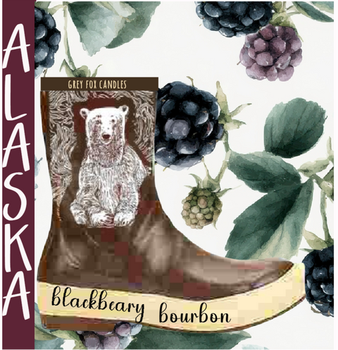 Candle labeled 'Blackbeary Bourbon' with a bear illustration on a boot, surrounded by berries and leaves.