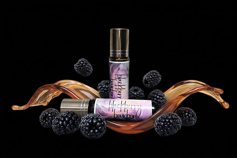 Two small roll on perfume bottles with blackberry design and blackberries on a black background