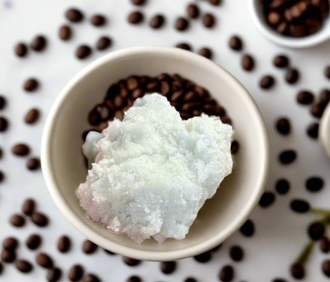 ESPRESSO SUGAR SCRUB IN A BOWL SURROUNDED BY ESPRESSO BEANS
