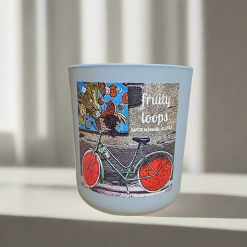 12 oz glass candle jar with bicycle design and 'fruity loops' text on a light background