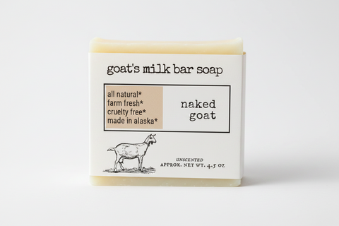 A clean product graphic for goat's milk bar soap labeled 'naked goat' on a white background. The design includes the text 'goat's milk bar soap,' a beige callout box with 'all natural,' 'farm fresh,' 'cruelty free,' and 'made in alaska,' a black goat illustration, and 'UNSCENTED APPROX.