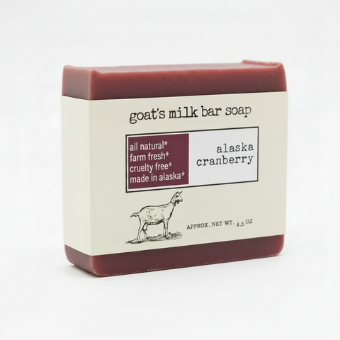 Goat's milk bar soap packaging label for 'alaska cranberry' scent, featuring a black goat illustration, product details, and a dark cranberry colored block with text on a white background.