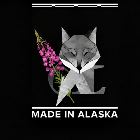 Geometric fox design with pink fireweed flowers and 'Made in Alaska' text on a black background
