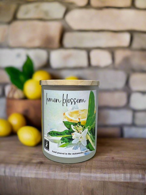 Candle labeled 'Lemon Blossom' with lemons and a stone wall in the background