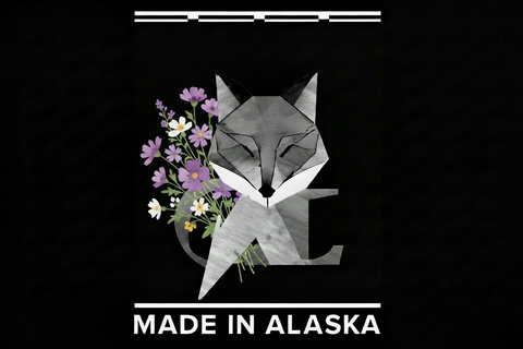 Geometric fox design with flowers and 'Made in Alaska' text on a black background