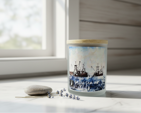 Candle with a scenic label on a windowsill